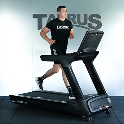 Model running on the Taurus T10.5 Pro Treadmill from a side view