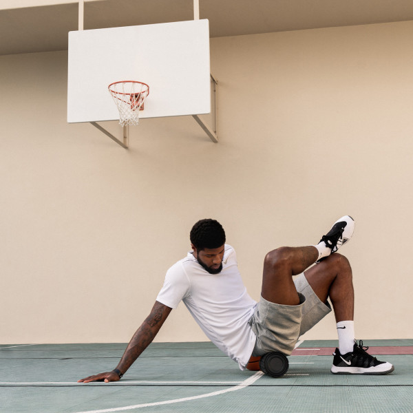 Using the Theragun Wave Roller under the glutes for targeted relief.