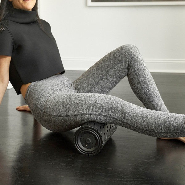 Using the Theragun Wave Roller under the hips for targeted relief.