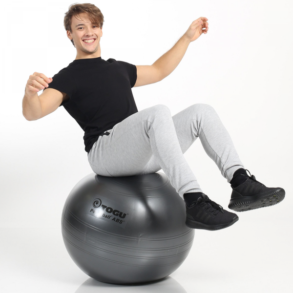 A Boy balancing on TOGU Powerball ABS