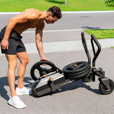 Image of a model loading the Torque TANK M1S with weight plates.