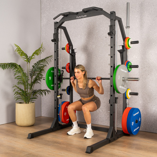 Image of a model performing a squat, using the Tunturi SM70 Smith Machine.