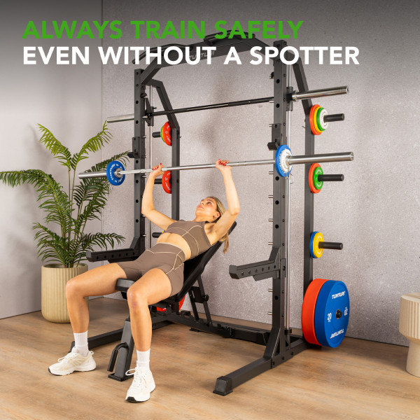 Product image of the Tunturi SM70 Smith Machine with a model performing a bench press.
