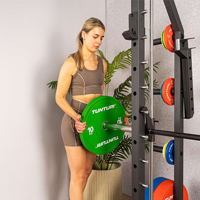 Image of a model loading the SM70 with Olympic weight plates