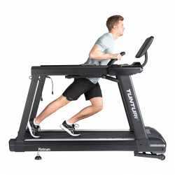 Model performing a sled-style training exercise on the Tunturi Platinum Core Treadmill