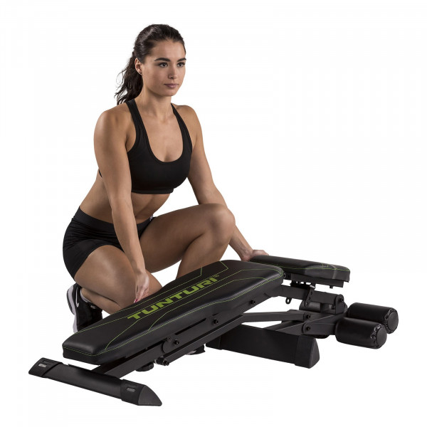 Person folding the Tunturi UB80 Weight Bench for storage