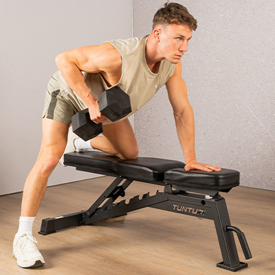 Model using the Tunturi UB70 to perform a dumbbell bent-over row