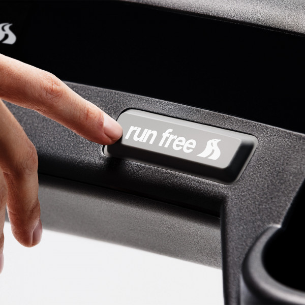 User pressing Run Free button on Wahoo KICKR RUN Smart Treadmill