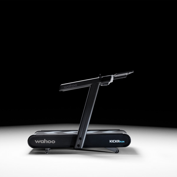 Side view of the Wahoo KICKR RUN Smart Treadmill on dark background