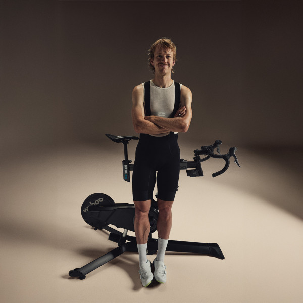 Model standing next to the Wahoo KICKR BIKE PRO