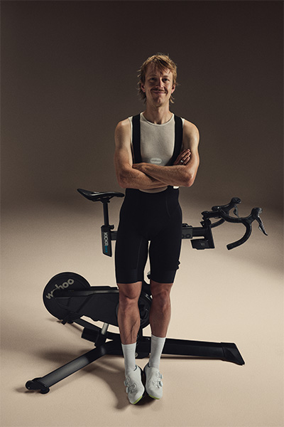 Model standing next to the Wahoo KICKR BIKE PRO
