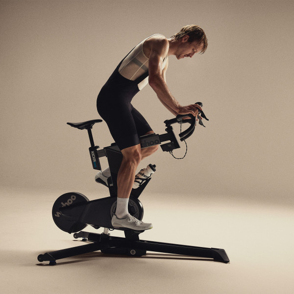 Model riding the Wahoo KICKR BIKE PRO in aero position