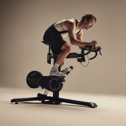 Model riding the Wahoo KICKR BIKE PRO seated