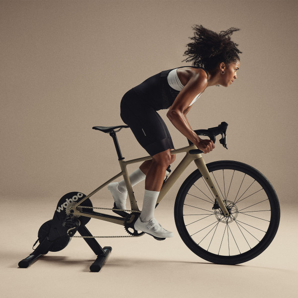 Person training indoors on the Wahoo KICKR CORE 2 trainer side profile