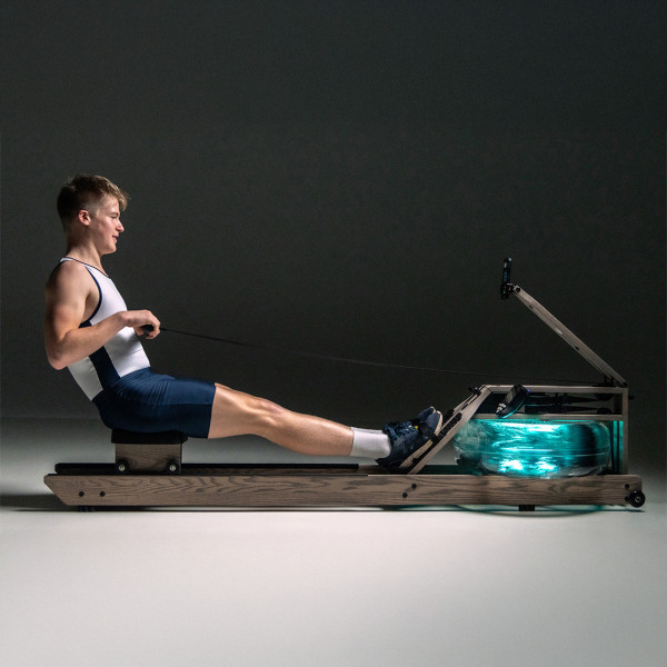 Side view of a person using the WaterRower rowing machine with the LightRing illuminated