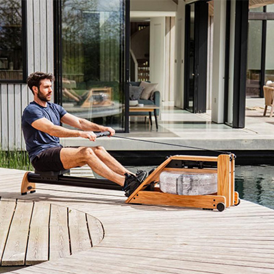 Model rowing on the WaterRower Hybrid Rowing Machine outdoors 