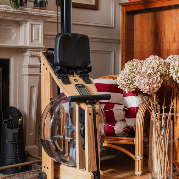 Angled view of the WaterRower Hybrid Rowing Machine stored upright