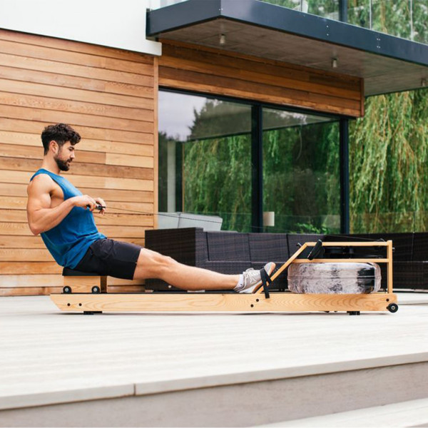 User rowing outdoors on the WaterRower Pure VR3 Oak Rowing Machine